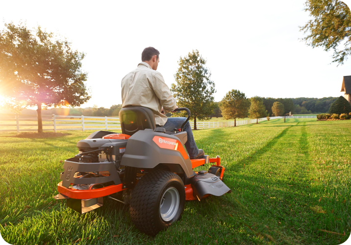 Man on Ride On Lawn Mower in Large Property