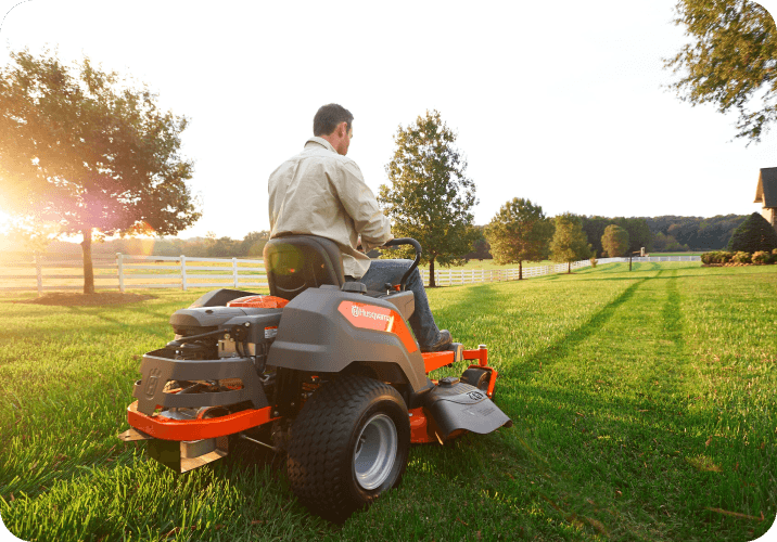 Man on Ride On Lawn Mower in Large Property